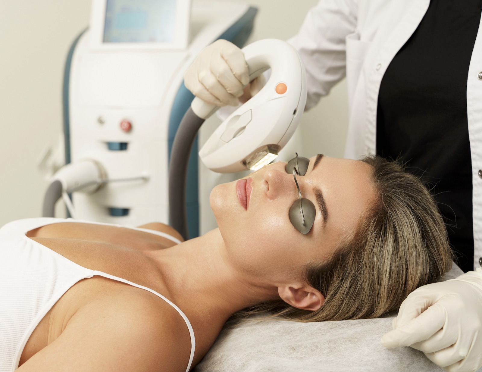 Patient receiving IPL (Intense Pulsed Light) treatment with protective eye shields in place